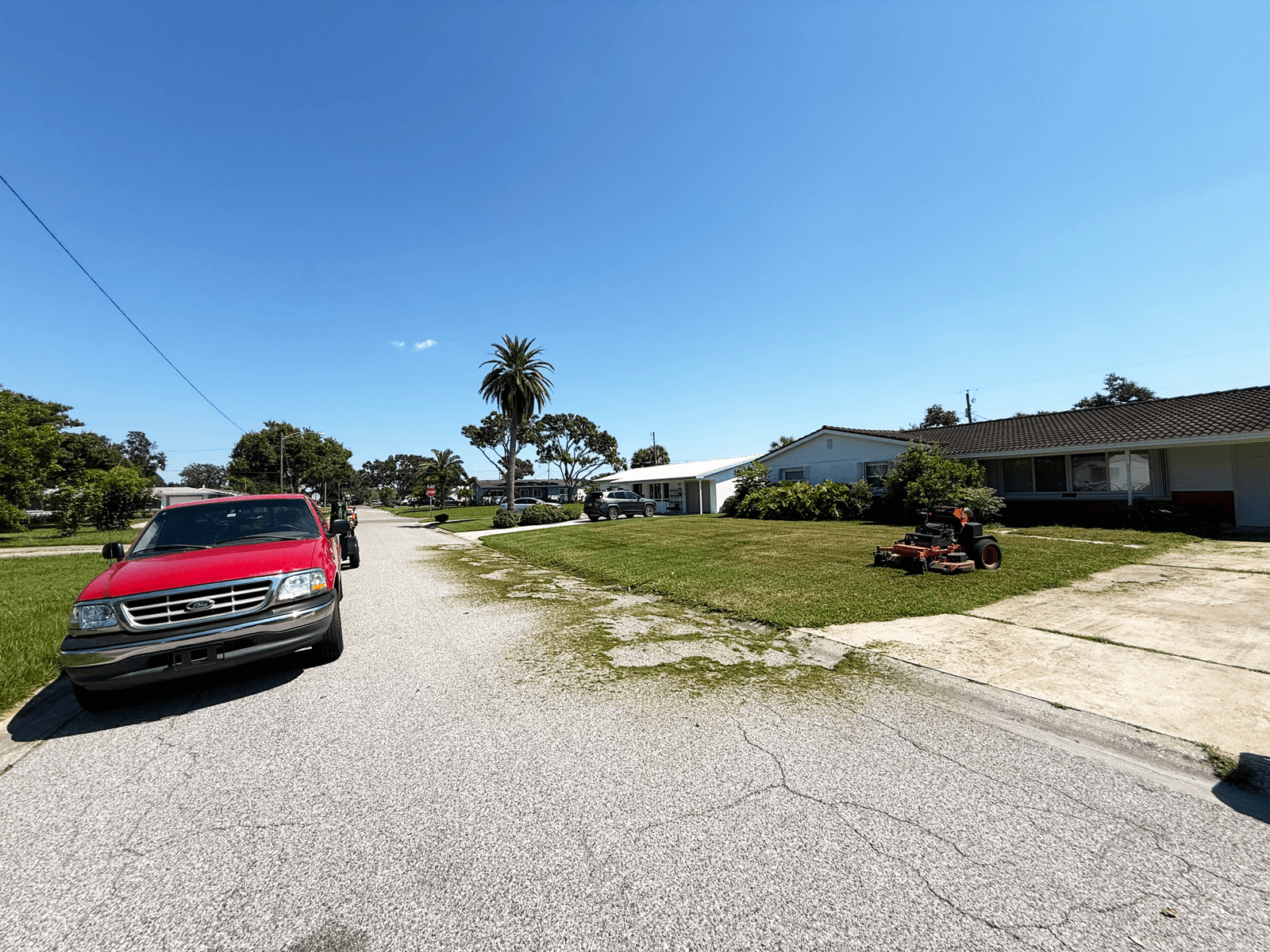 Green Cut Lawn Care service truck and zero-turn mower stationed at a residential property in St. Petersburg, FL.